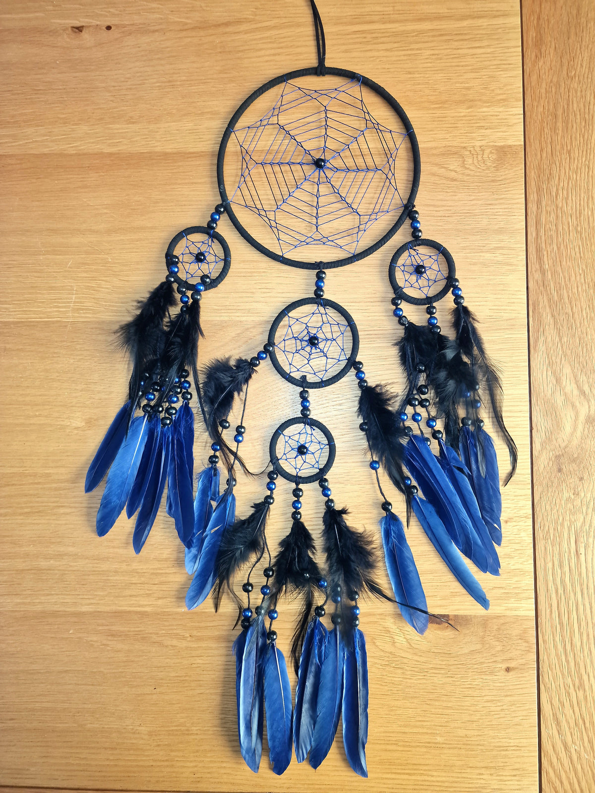 Spider Web Dreamcatcher | Gothic Halloween Wall Décor with black and blue feathers and beaded web hoops