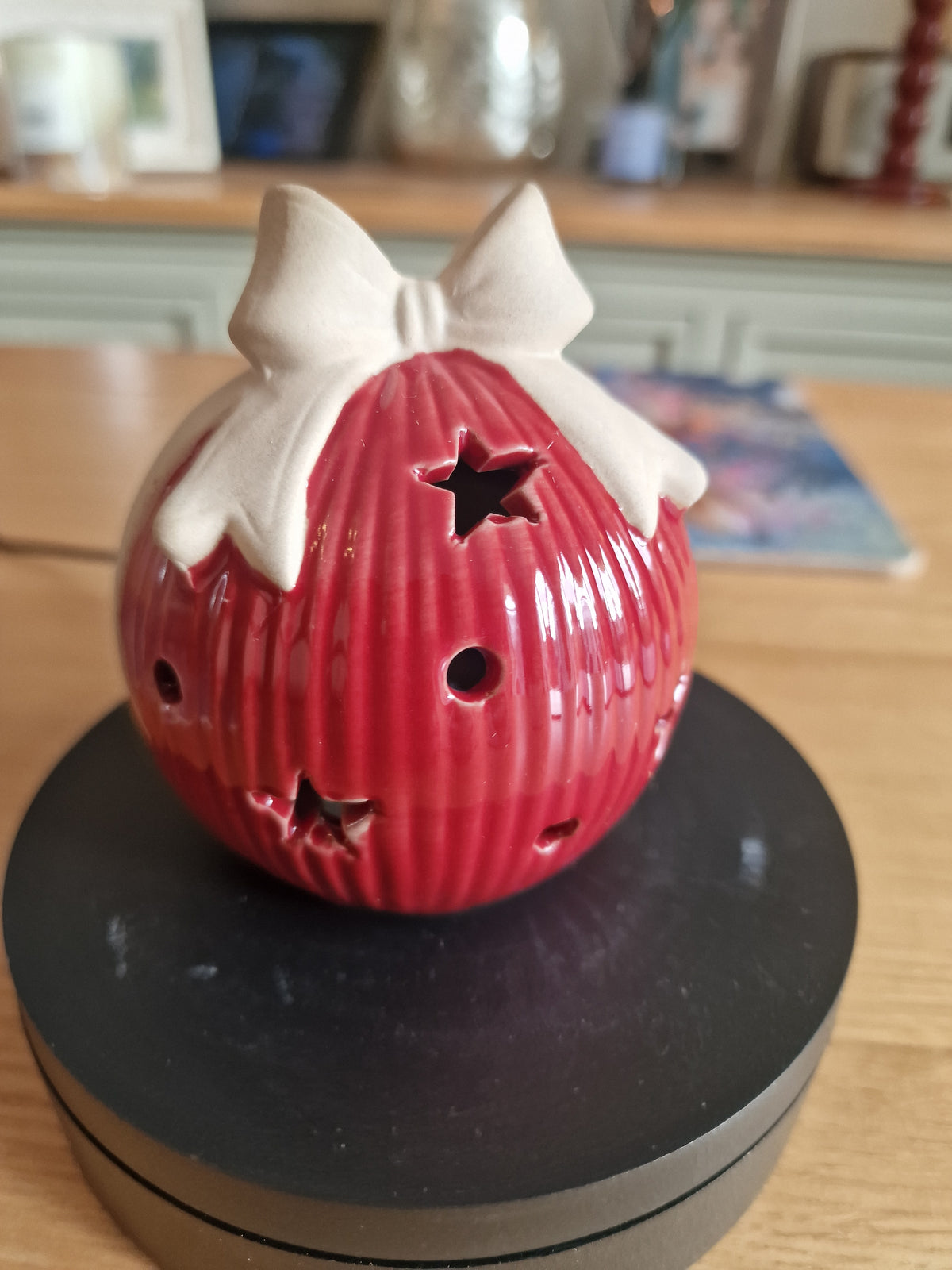 Red Ceramic Led Bauble With Bow 10cm in glossy red ceramic with star cutouts and white bow detail